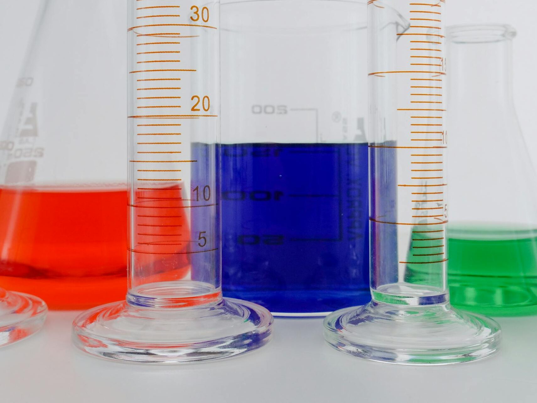 Close-up of colorful liquids in various laboratory glassware, perfect for science themes.